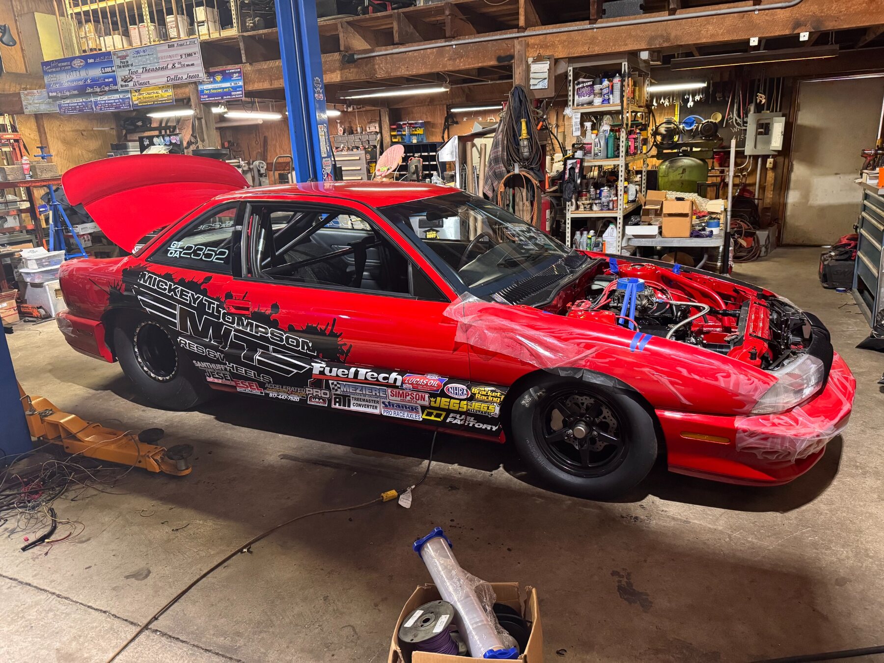 Red client race car under construction in the M20 shop