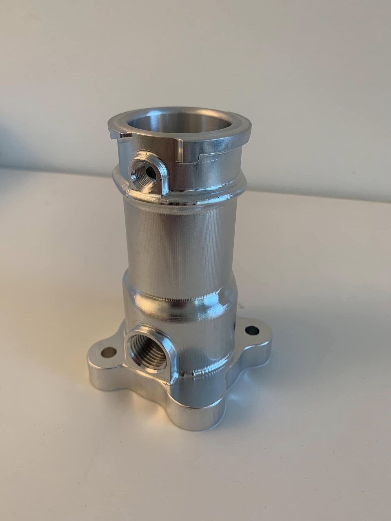 Custom-machined aluminum housing on a white background