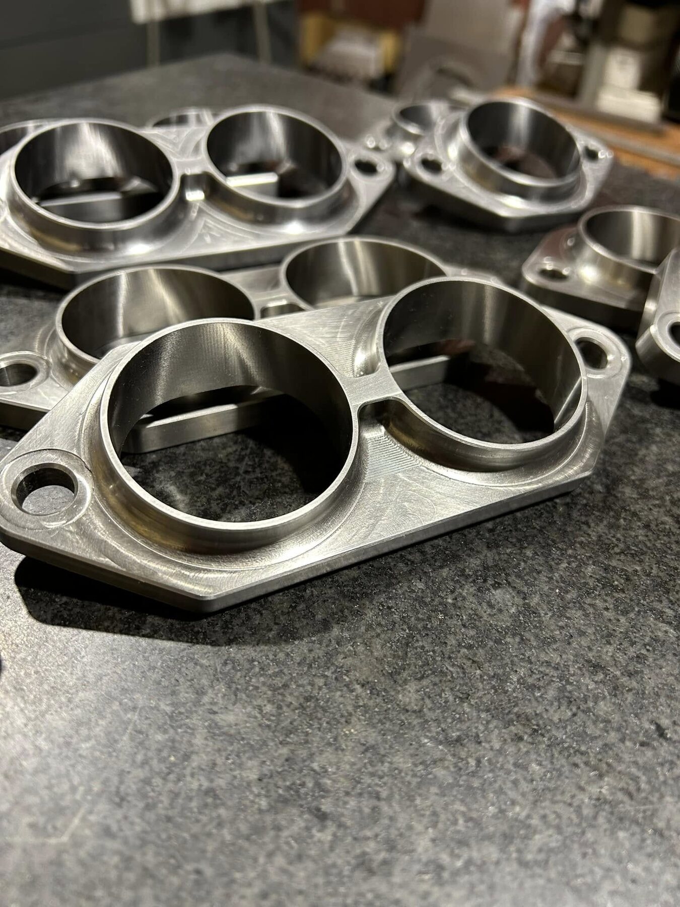Small-run machined aluminum rings arranged on a workbench