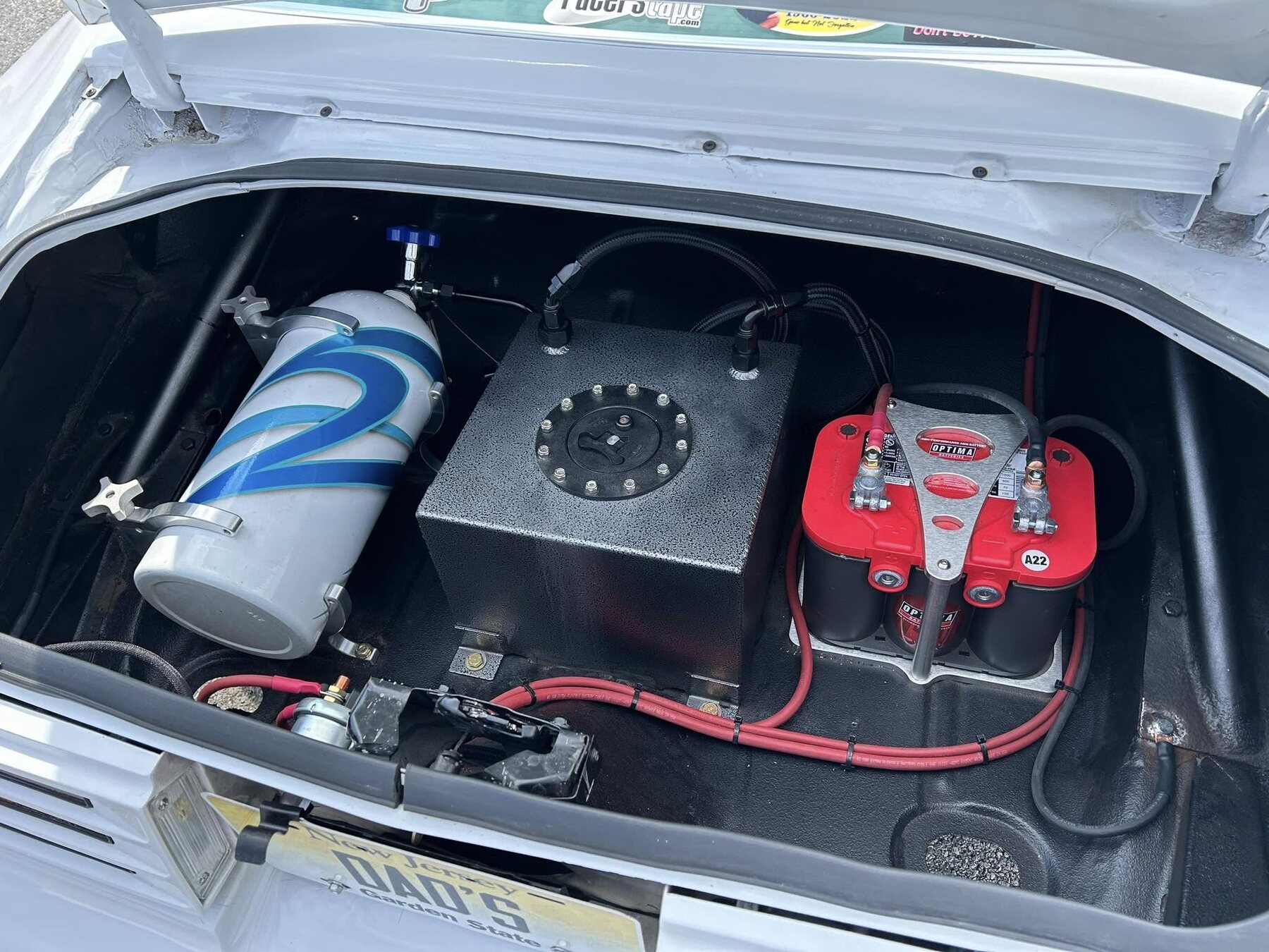 Rear-mounted race car tank, pump, and plumbing system